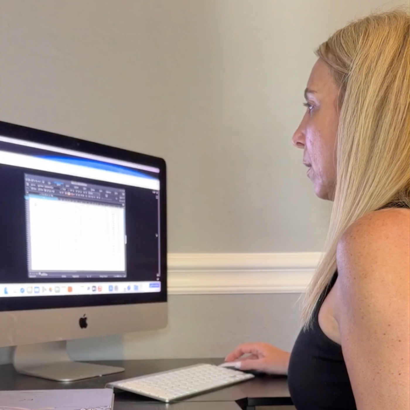 Woman working at a computer with focused attention