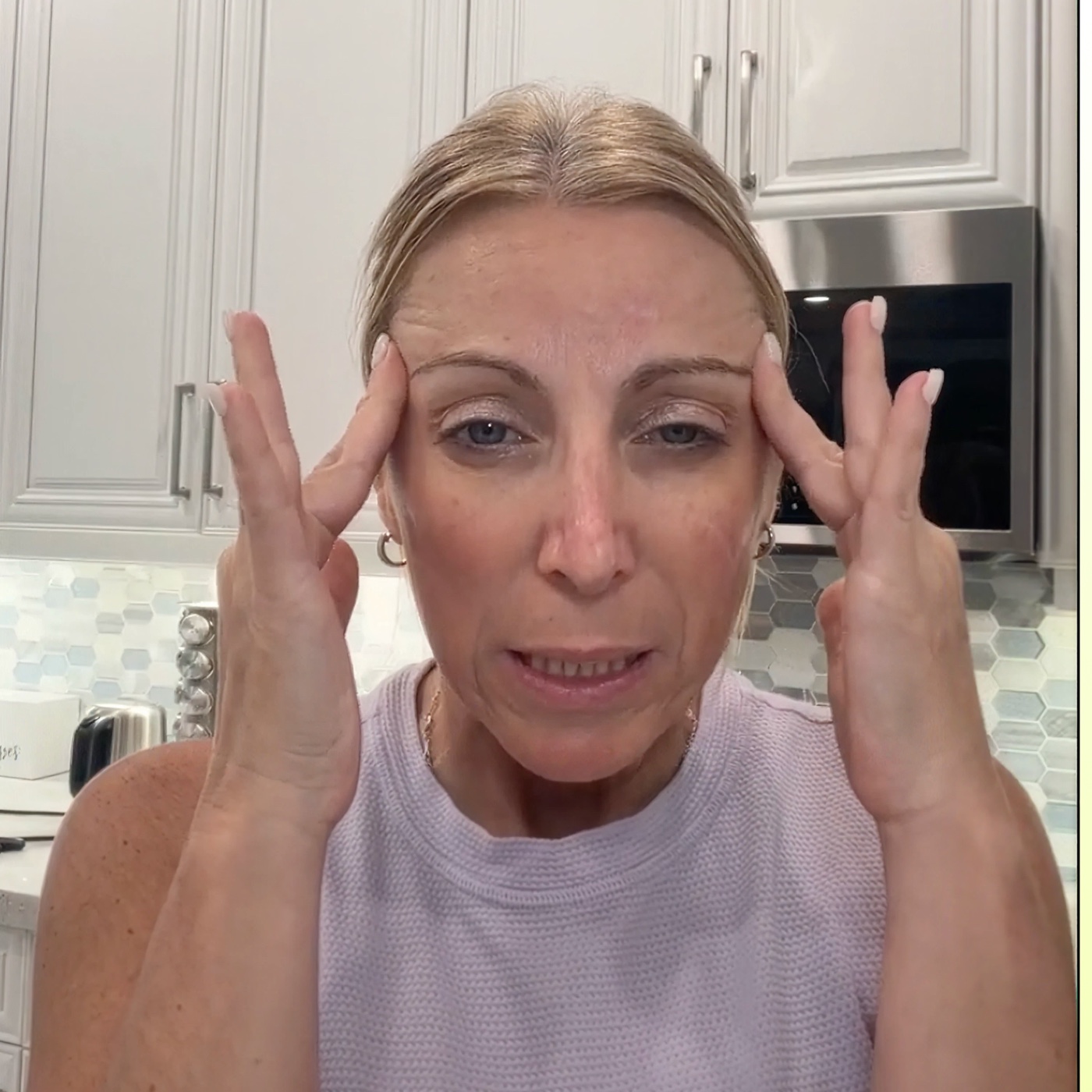 Woman touching her temples while feeling stressed